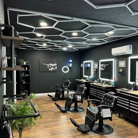 Ironside Barber Co. shop interior — hex-lit ceiling, black leather chairs, mirrored stations